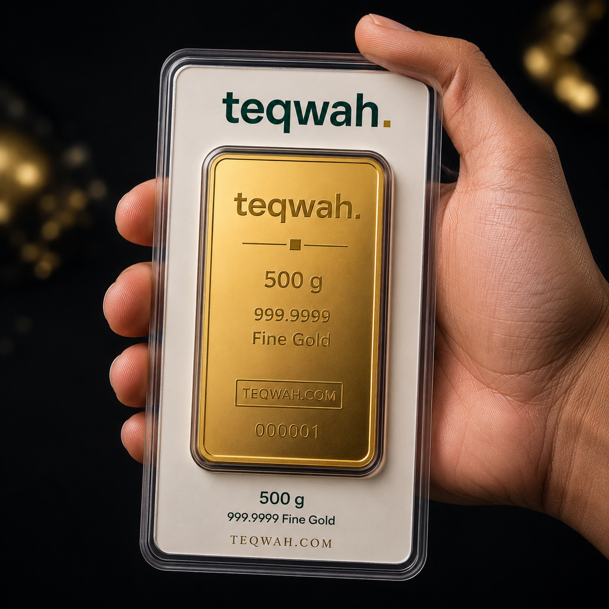 Teqwah 500 gram 999.9999 fine gold bullion bar in a protective sleeve with card insert, held in hand